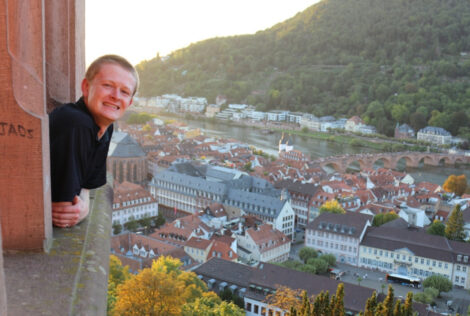 Chris leans out a window of Heidelberg Castle.
