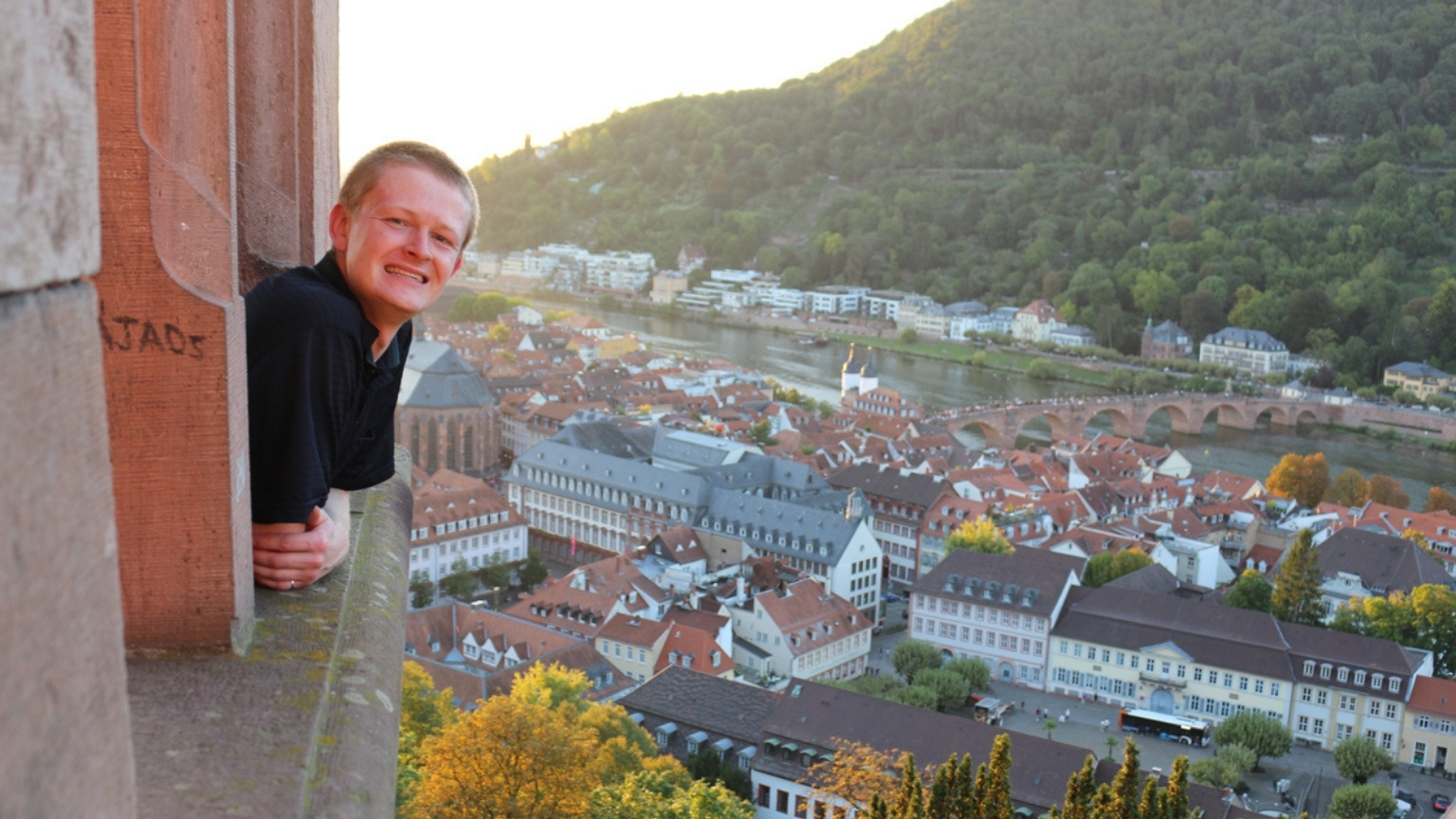 Chris leans out a window of Heidelberg Castle.