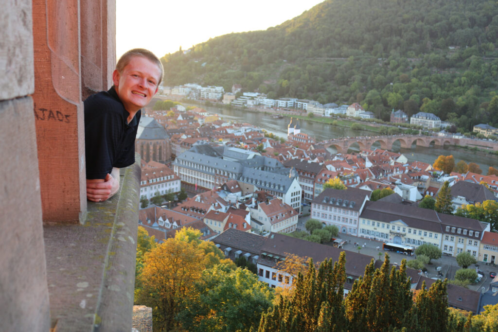 Chris leans out a window of Heidelberg Castle.