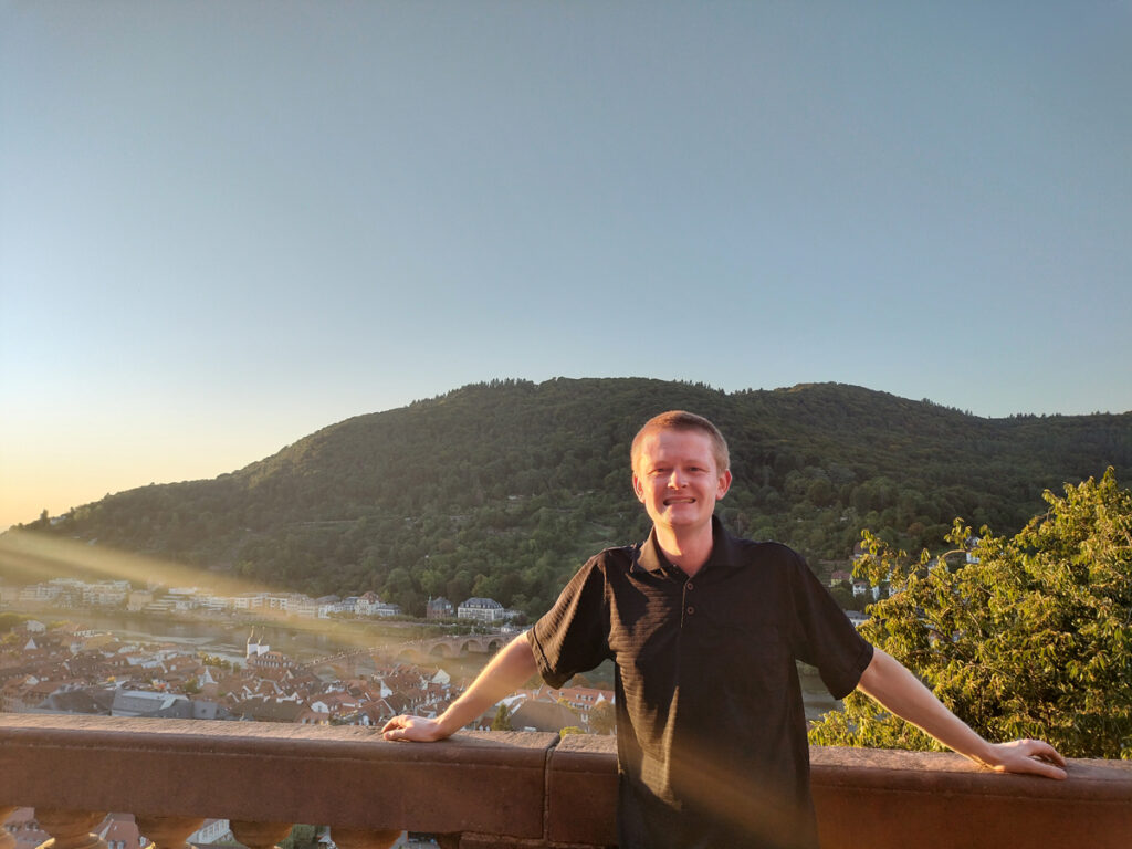 Chris poses in front of mountains