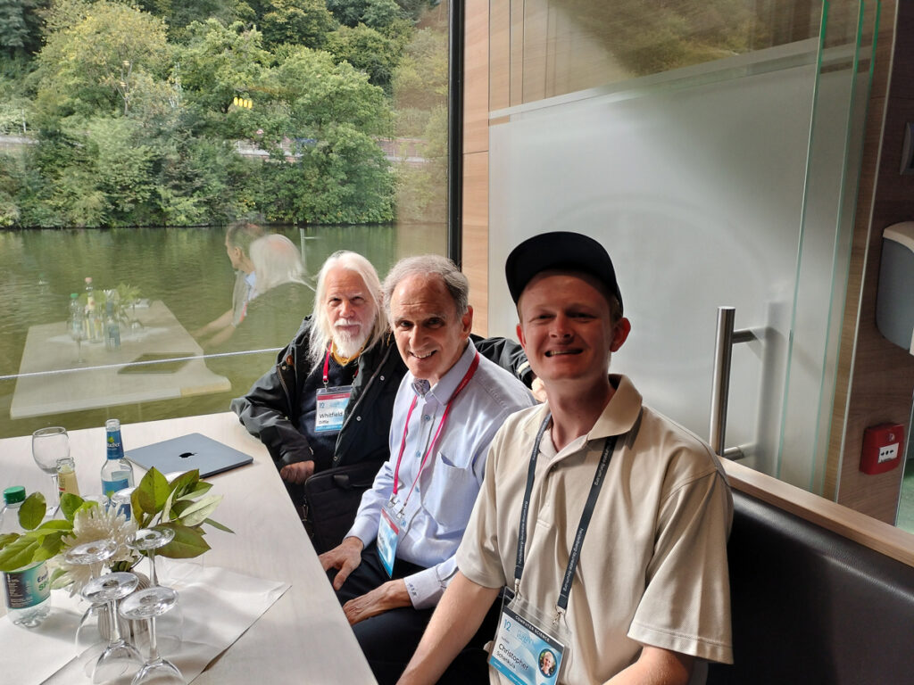 Chris on a boat posing with Drs. Diffie and Hellman.