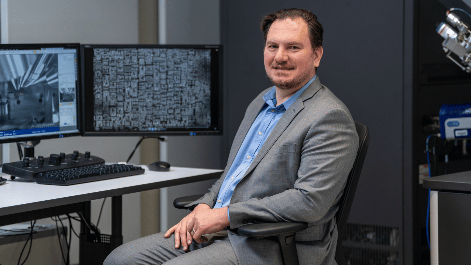 Nabil Bassim sits in front of a desktop computer.