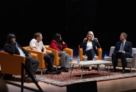Martin Williams from the University of Guelph; Nobel Laureate and Stanford professor emeritus Carl Wieman; Wilfrid Laurier physicist Shohini Ghose, Nobel laureate and University of Waterloo professor Donna Strickland and panel moderator Rob Cockcroft sit in chairs on a stage during the panel.