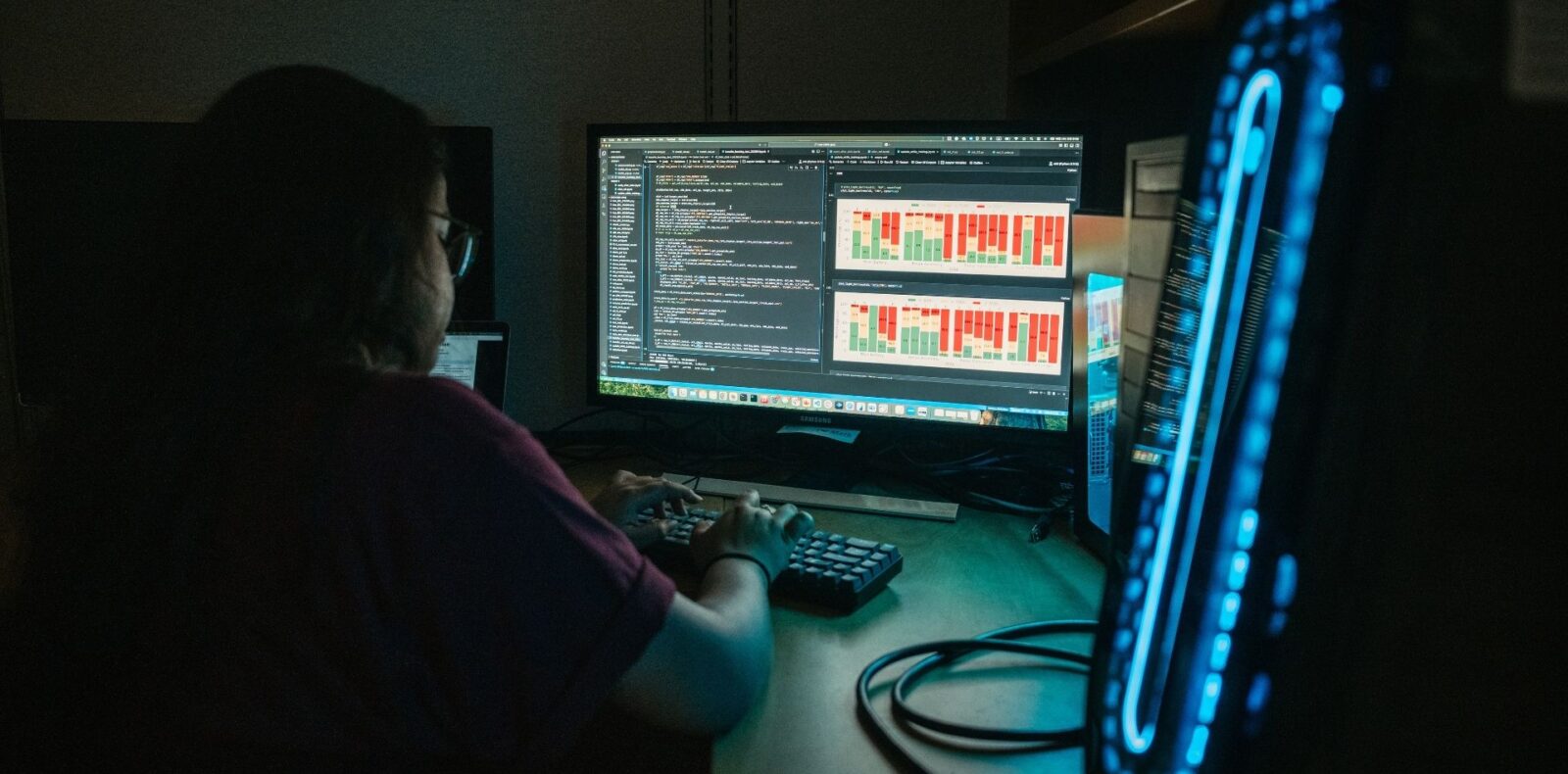 Person operating computer in a dark room