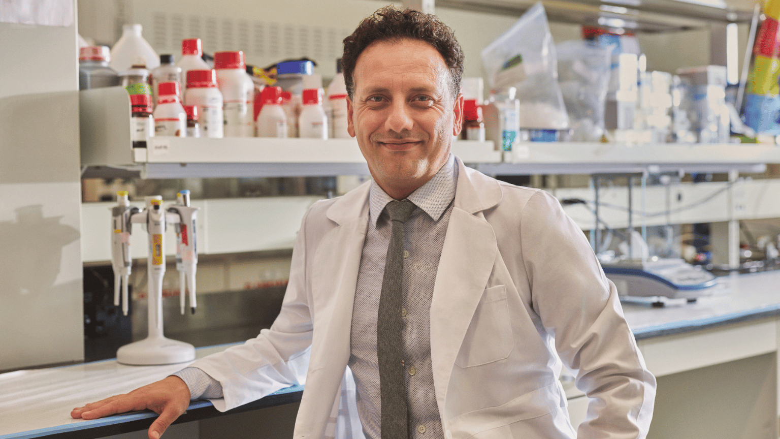 Tohid Didar leans on a counter in a lab coat.
