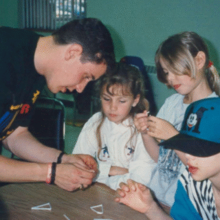 Counselor helping kids at Venture Summer Camp in 1994