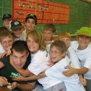 Kids hugging counselor at Venture Summer Camp in 2007
