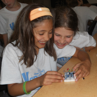 Kids playing with a breadboard at Venture Summer Camp 2013