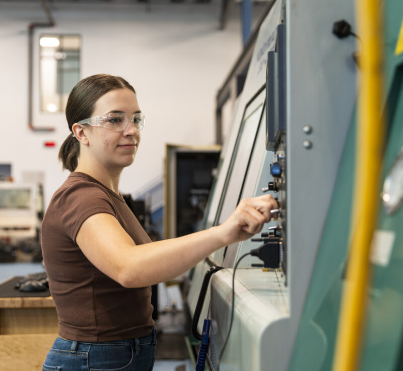 Student working at a machine on a co-op