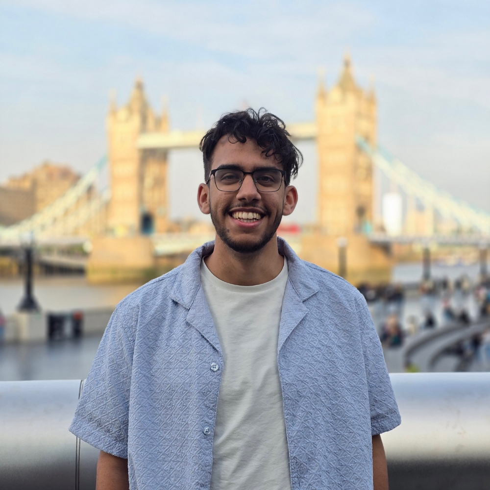 Hady posing in front of a bridge