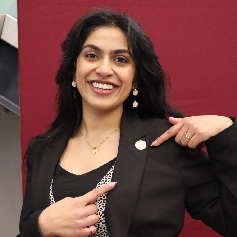 Muskaan points to an iron ring pin on her lapen