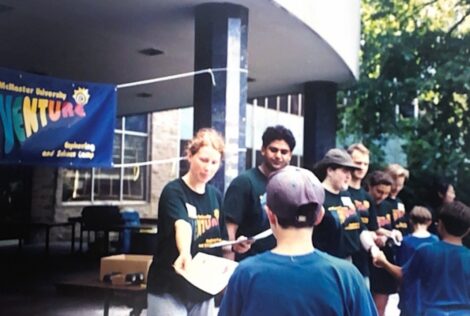 Venture staff passing out packages to youth in front of JHE