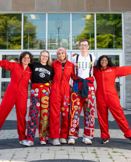 Students in red suits in front of JHE