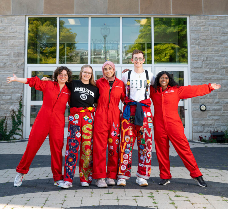 Students in red suits in front of JHE