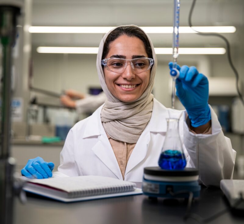 A person smiles while conducting a tritiation test.