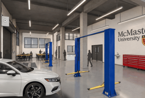 A rendering of the automotive lab with a vehicle on the left and McMaster logo on the wall.