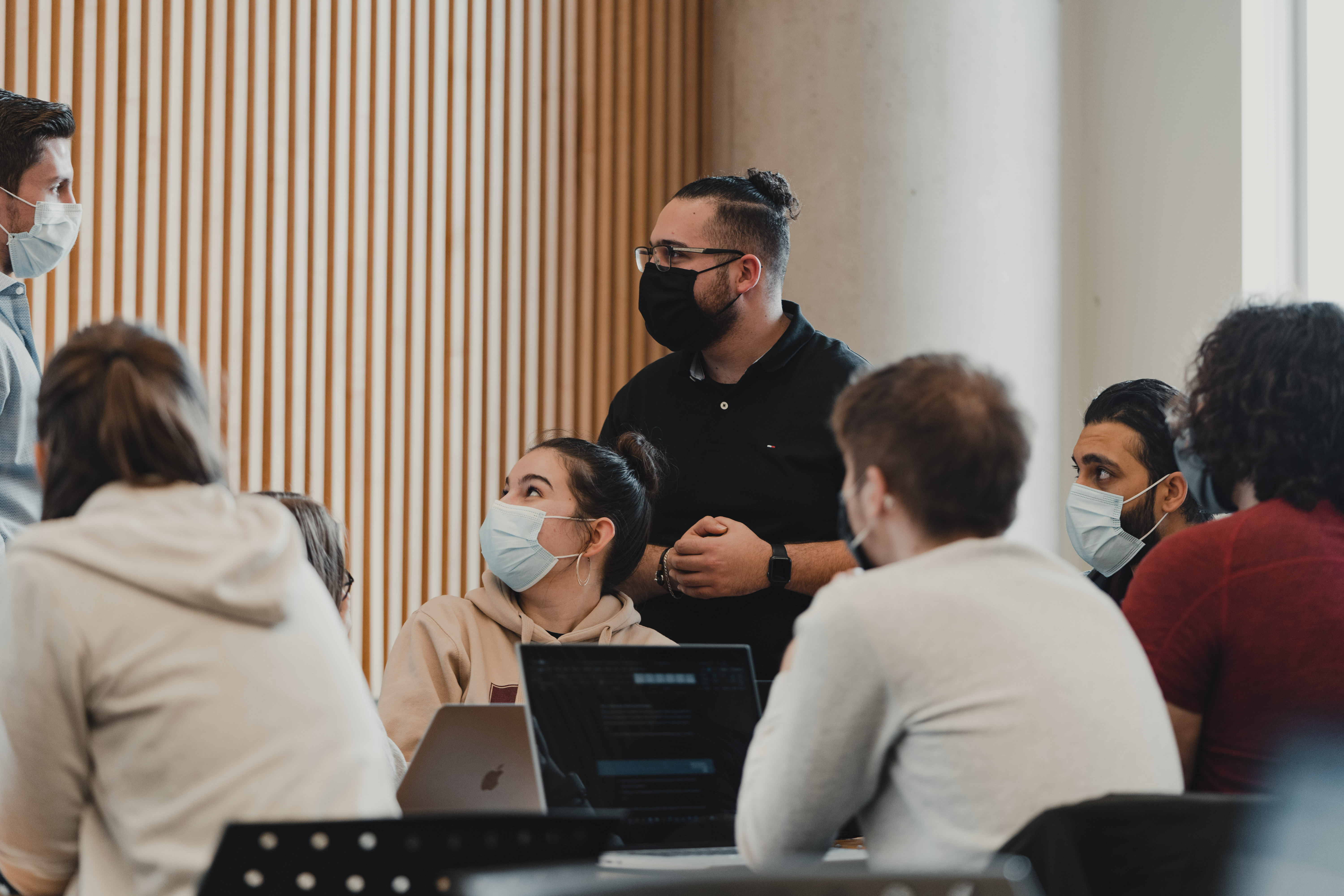 A group of masked McMaster engineering students in a classroom 