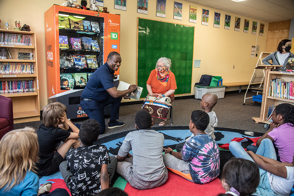 Brian Warren reads to kids as part of his organization Start2Finish.