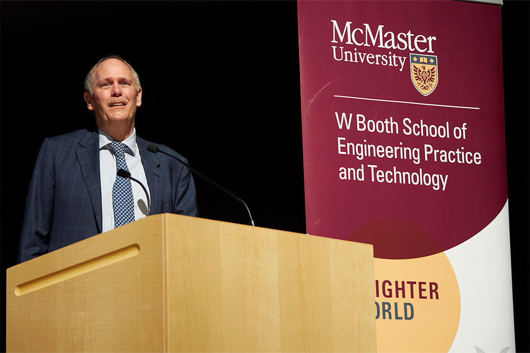 McMaster University President David Farrar stands at the podium.