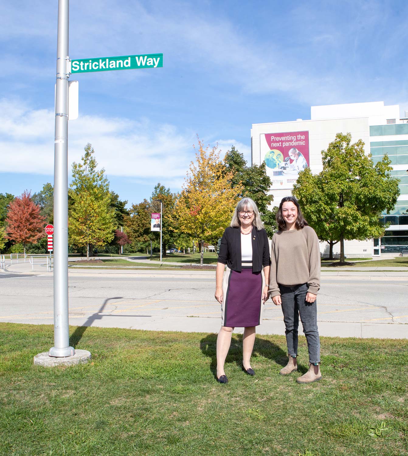 Donna Strickland stands with Emma Magee under the Strickland Way street sign