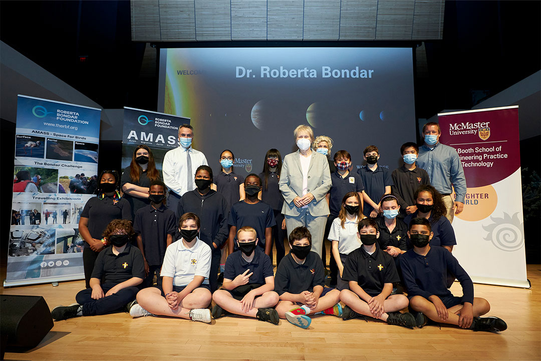 Roberta Bondar takes a group picture with a Grade 6 class from Canadian Martyrs Catholic Elementary School.